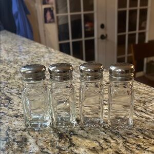 Set of Four Glass Shakers with Silver Tops